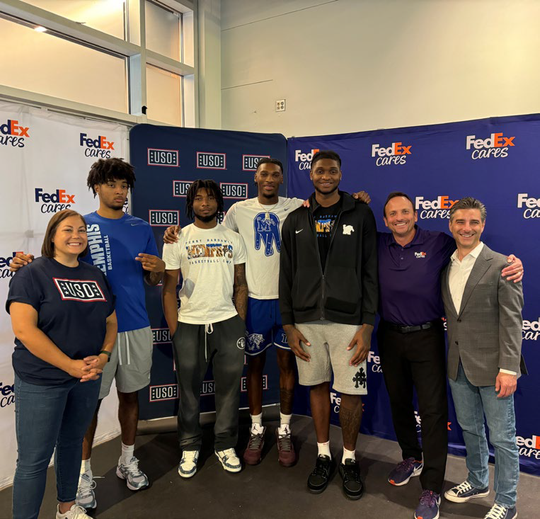 FedEx volunteers posing with USO members