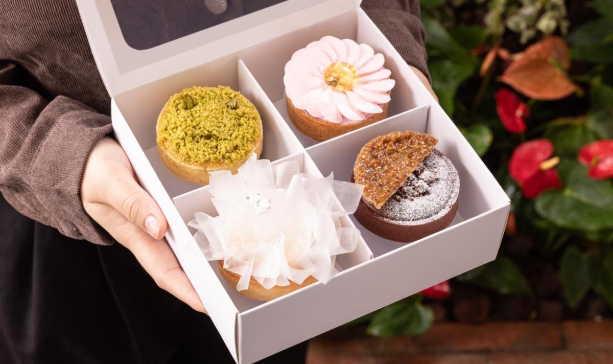 Someone holding a box of pastries