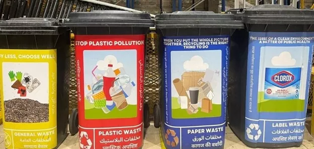 Four containers with labels indicating different types of waste