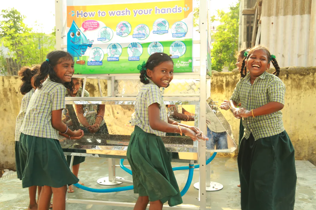 Kids in green uniforms laughing