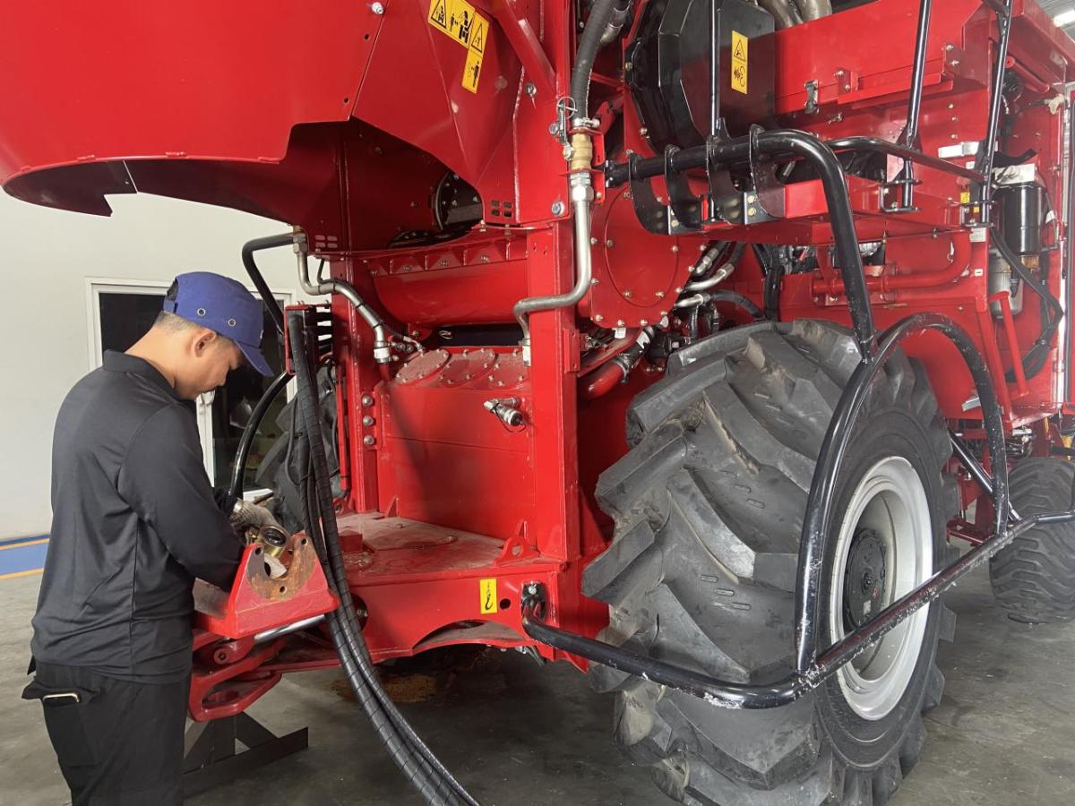 A person walking on agricultural machinery 