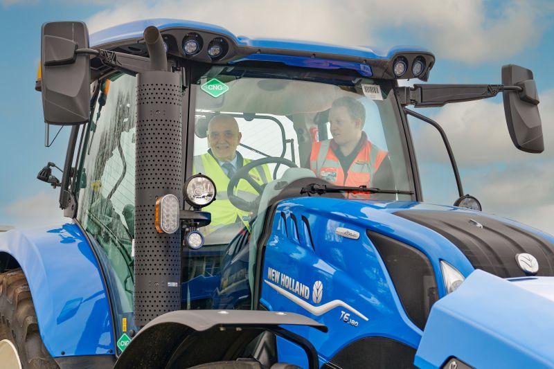 People inside the cab of a blue tractor