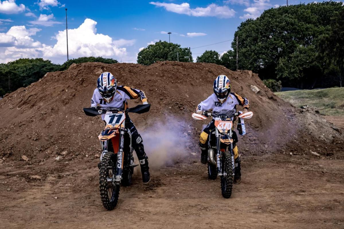 Two people riding motorbikes 