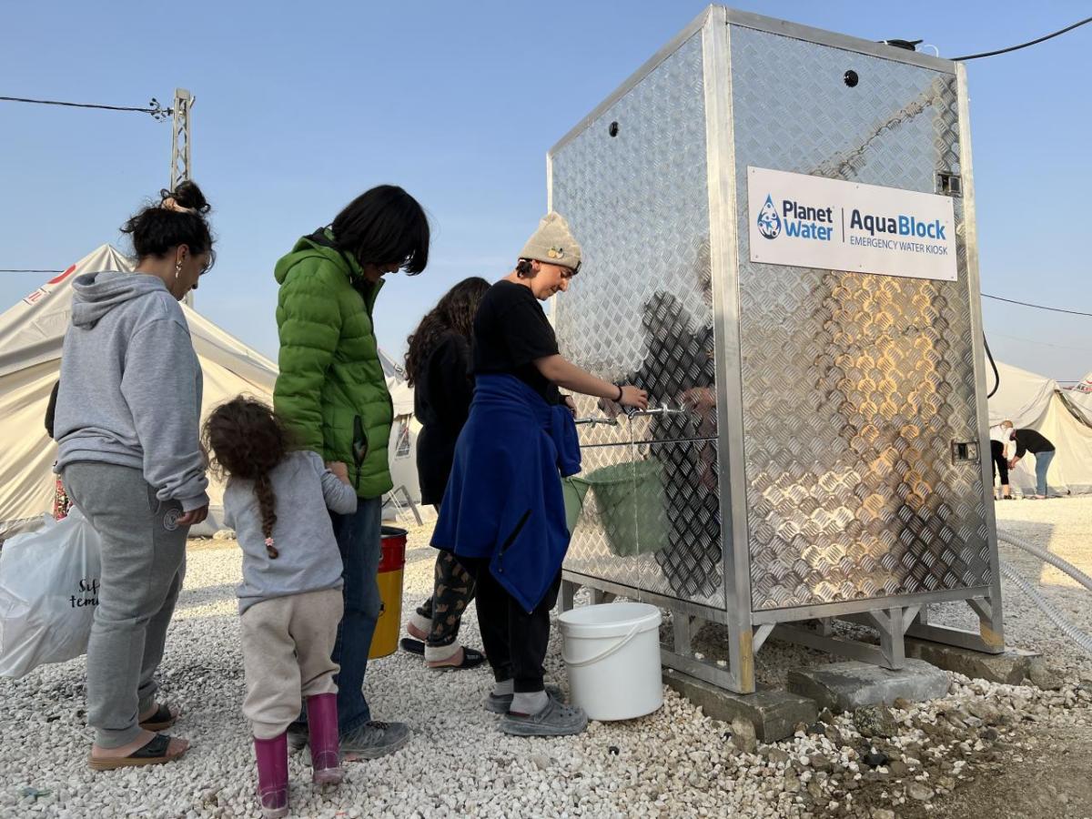 Clean, safe water being accessed at a relocation camp for earthquake survivors