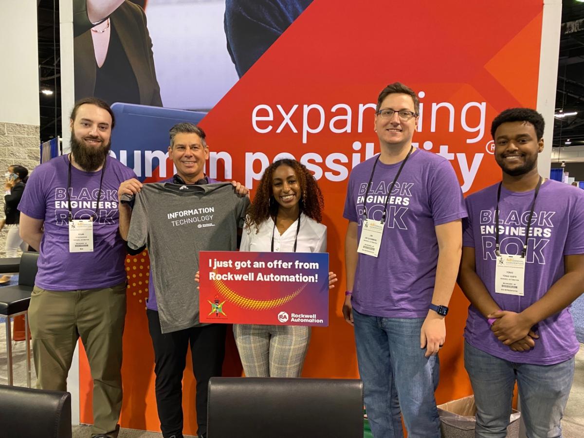 NSBE attendee Salina Tekele (center) celebrates her offer with (from left to right) Rockwell’s Dylan Kachigian, Chris Nardecchia, James Cayemberg, and Yonas Habte.