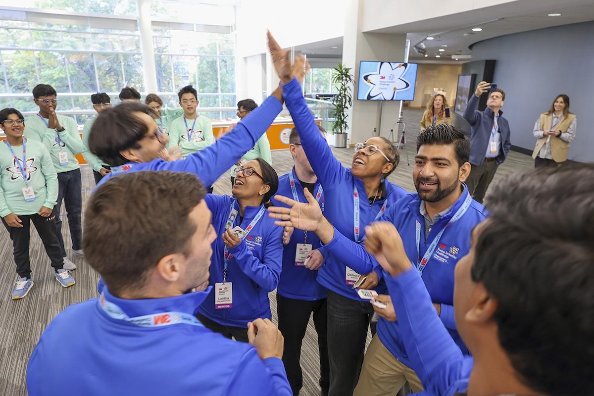 3M Young Scientists giving a high five.