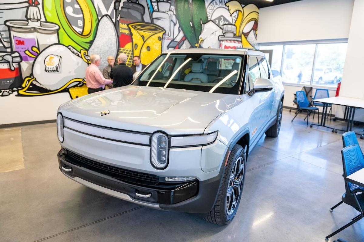 Rivian vehicle shown in front of the 3M Skills Development Center mural.