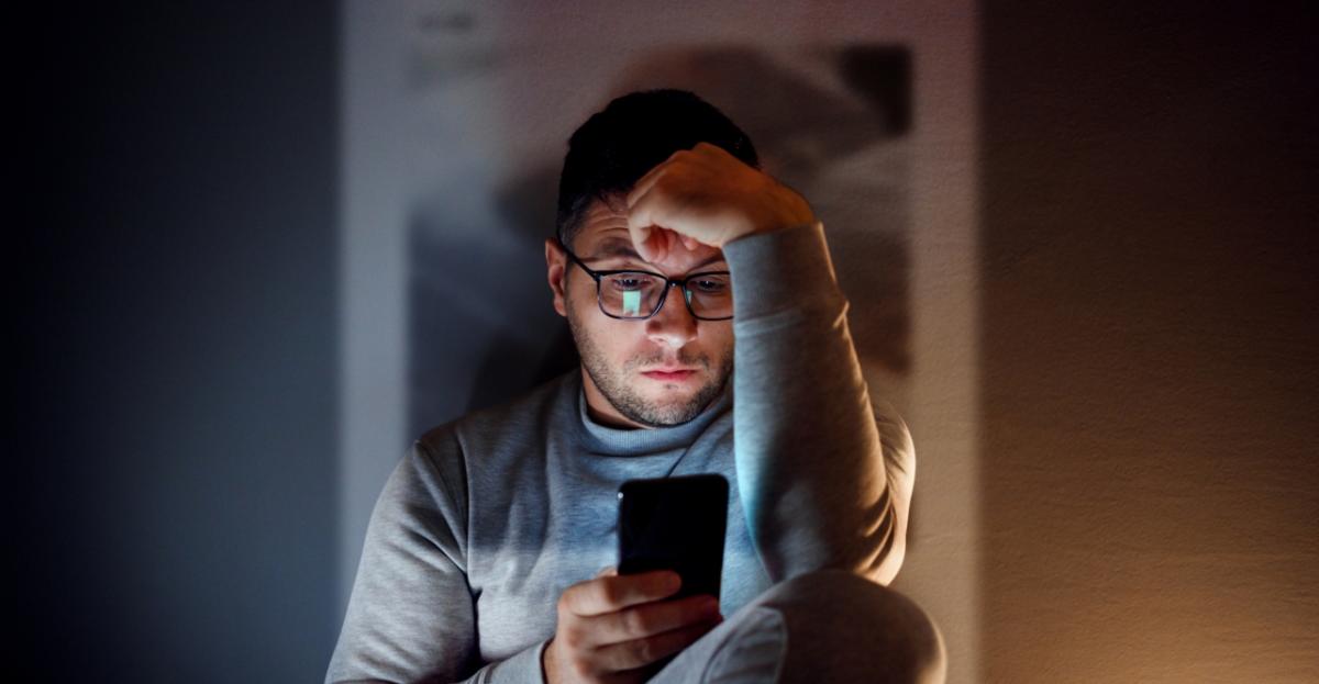 Person looking at smartphone in the dark