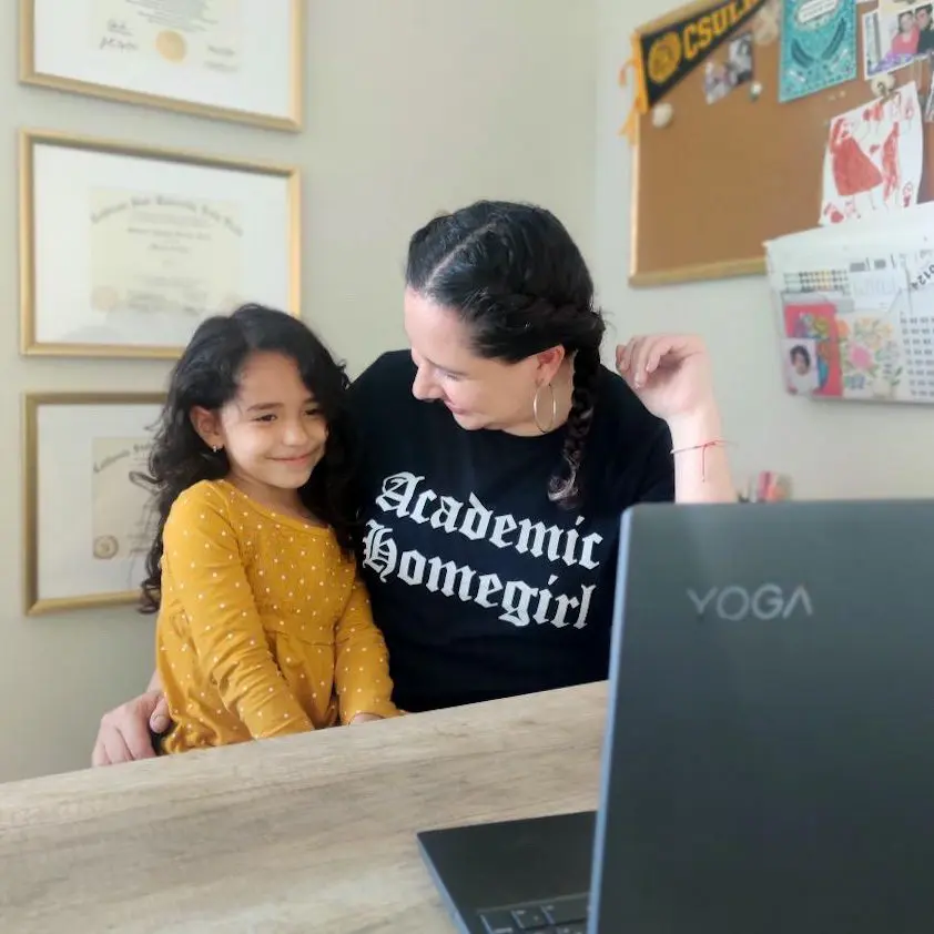 Dr. Maricela Becerra and child in front of laptop