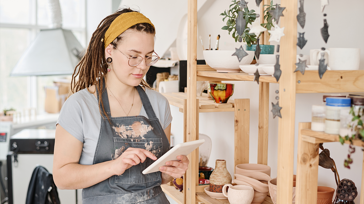 Small business owner shown using a tablet.