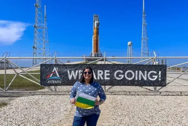 Joan Melendez Misner in front of rocket