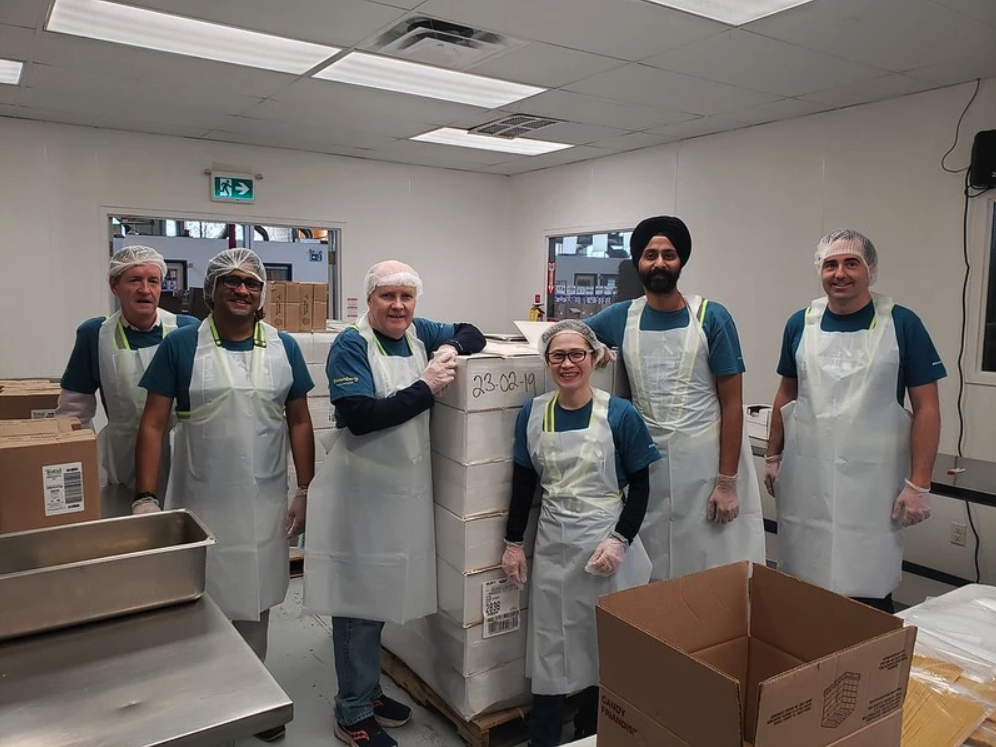 Group wearing aprons and smiling together