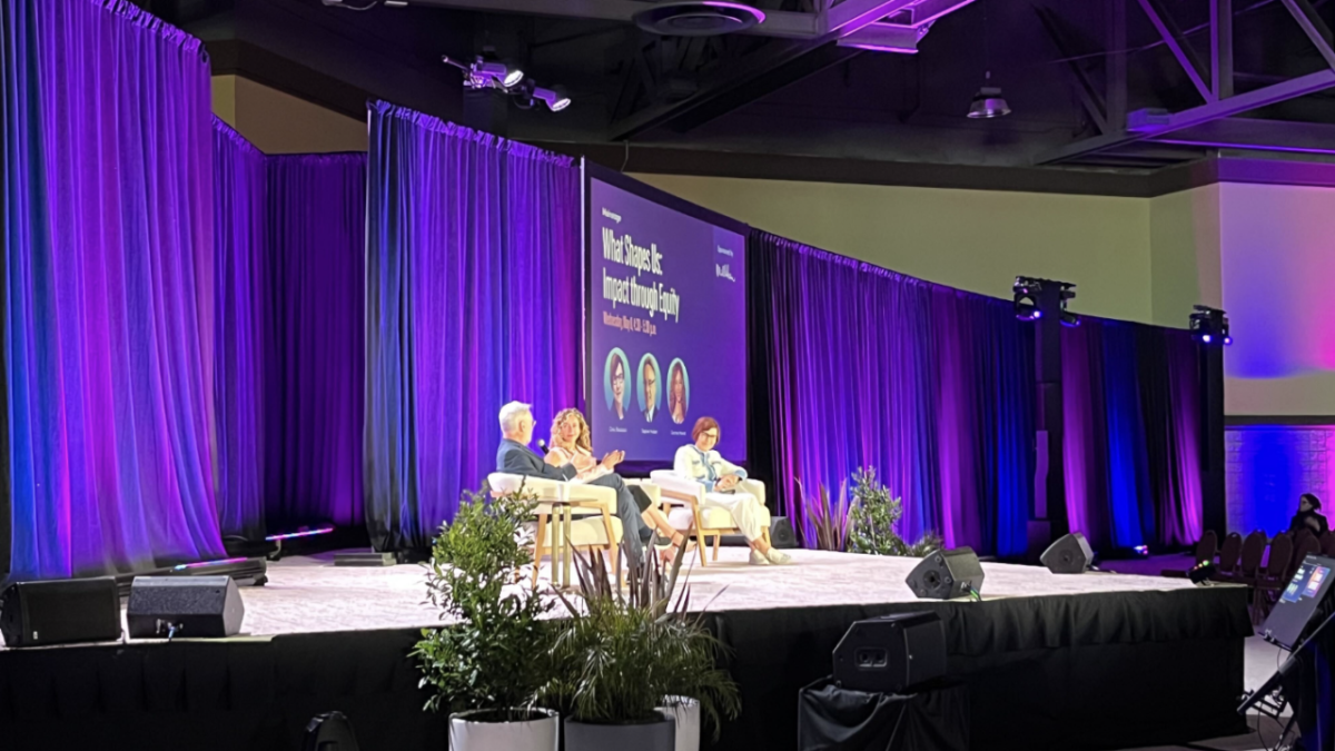 People sat on stage in front of an audience at the 2024 WELL Conference