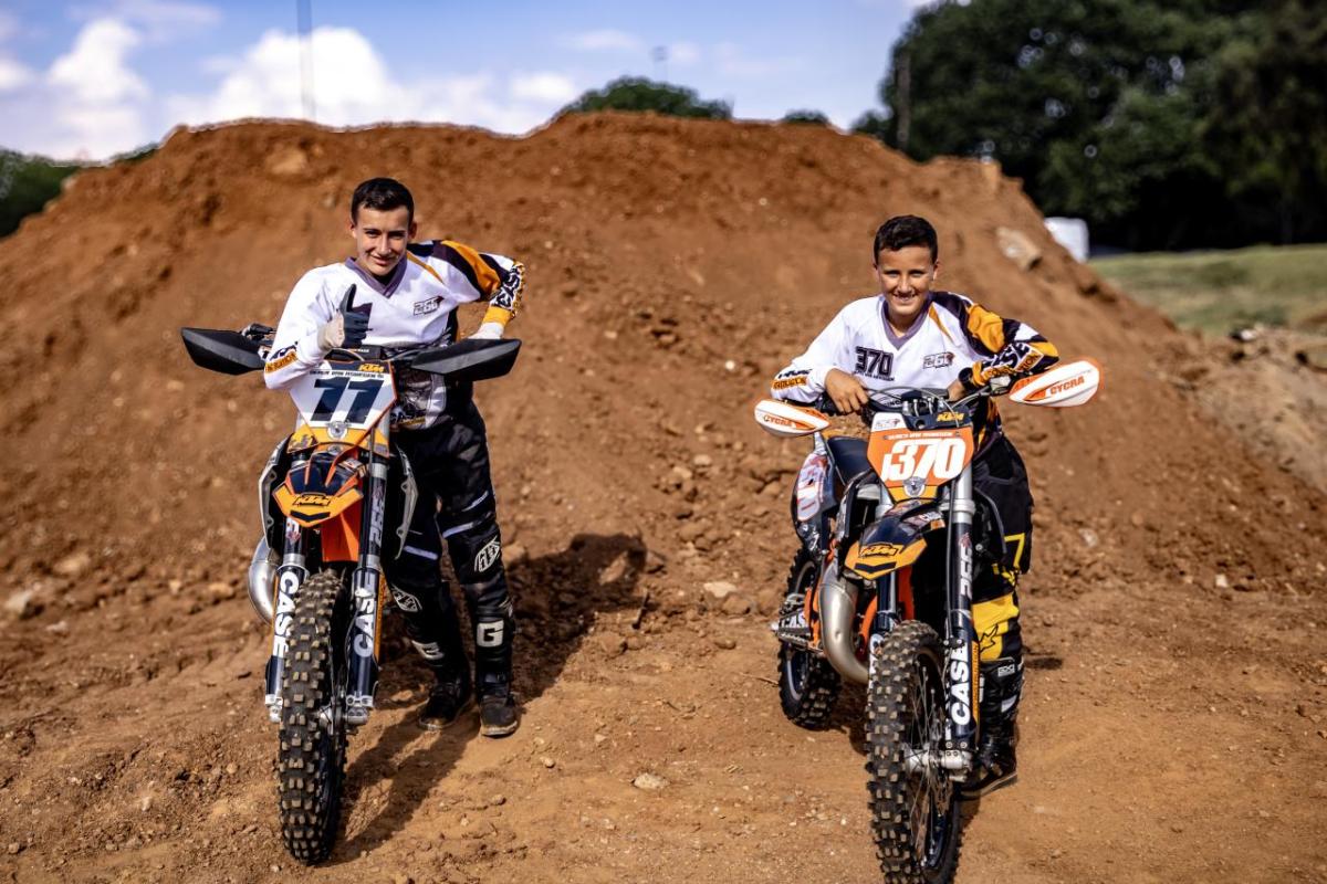 Two people sat on motorbikes 