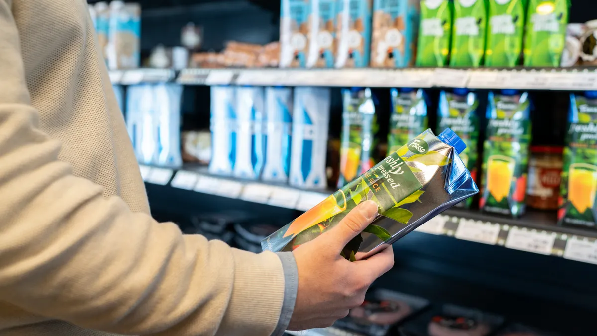 Photo courtesy of Tetra Pak Someone in a grocery store examining an item