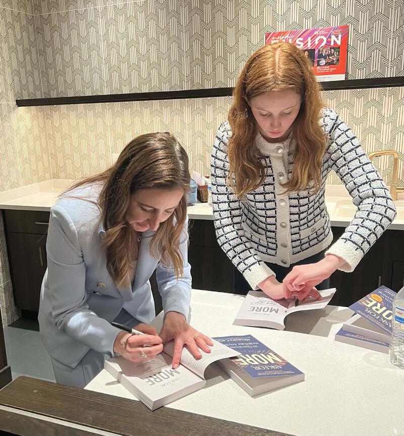 Columbia Law School professor Alexandra Carter and her daughter Caroline Carter Lembrich sign books
