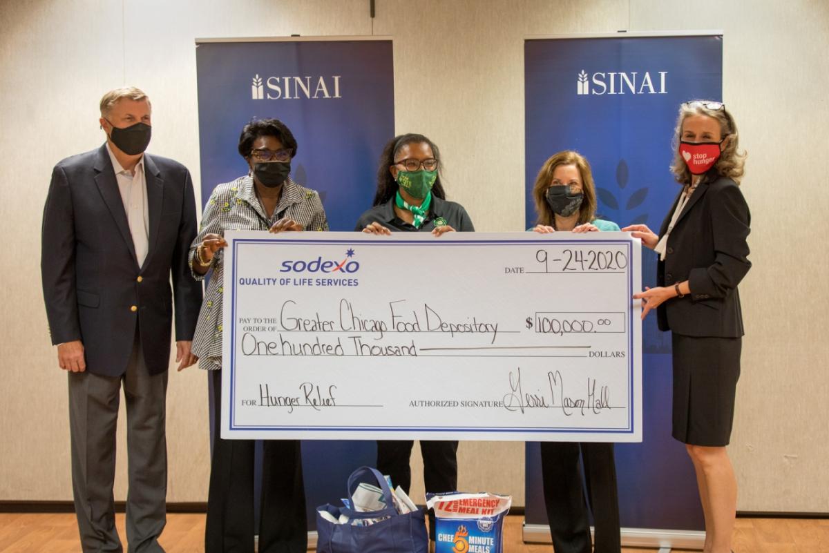 The Greater Chicago Food Depository accepts a $100,000 donation toward hunger relief from Sodexo.