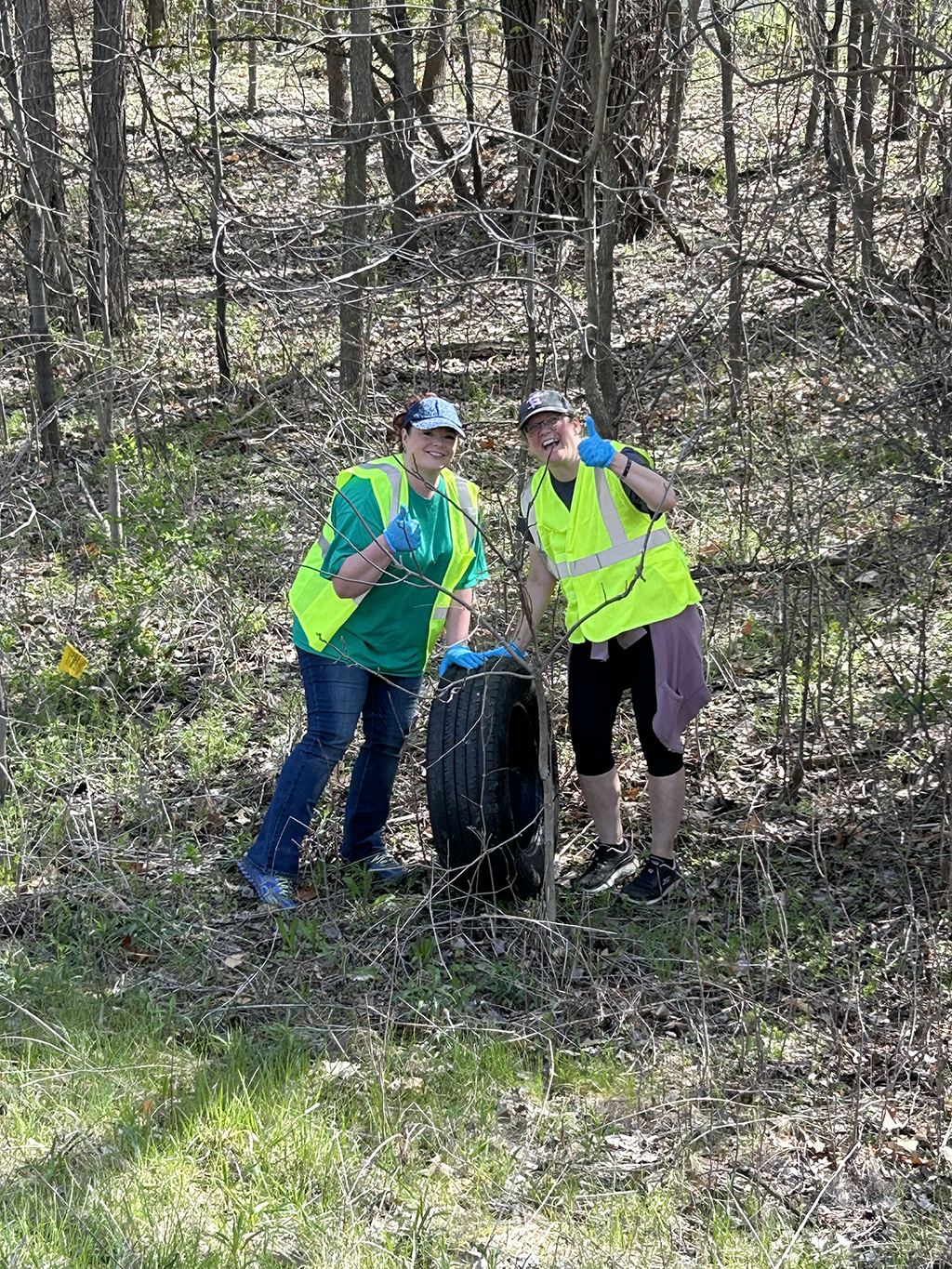 Two people in safety vests giving thumbs up