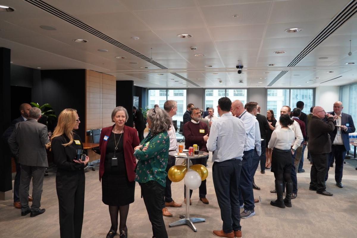 A group of people stood inside an office attending the ACE celebration 2024 event