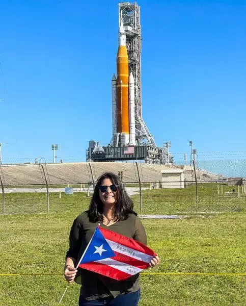 Joan Melendez Misner in front of rocket