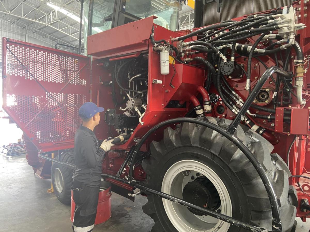 A person walking on agricultural machinery 