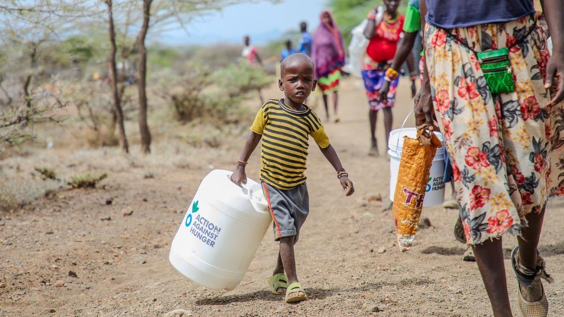 A child in Kenya carries a jerry bucket for safe water storage.