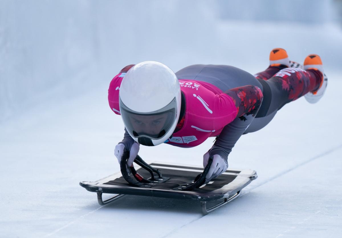 Olympic athlete jumping onto a sled