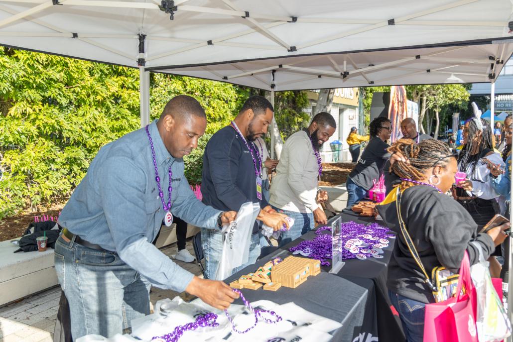 people working at a booth