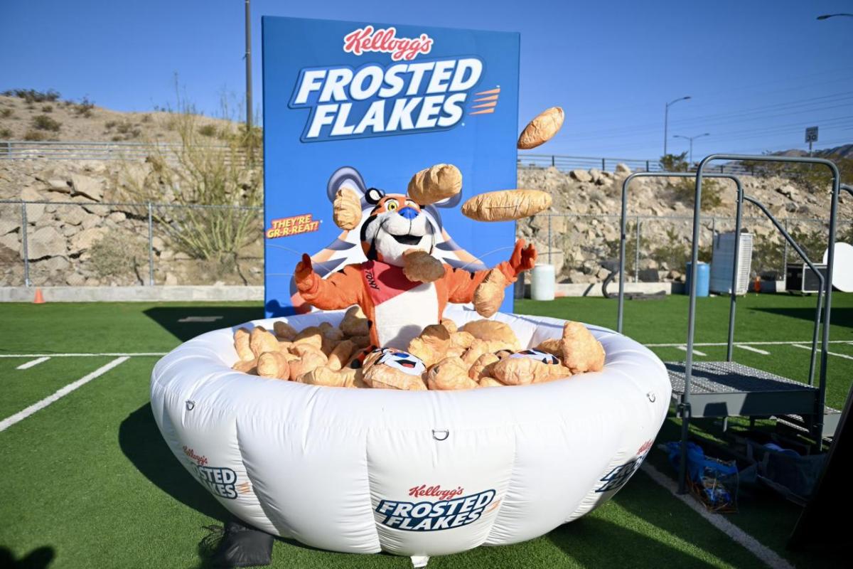 Tony the Tiger standing in inflatable bowl of Frosted Flakes
