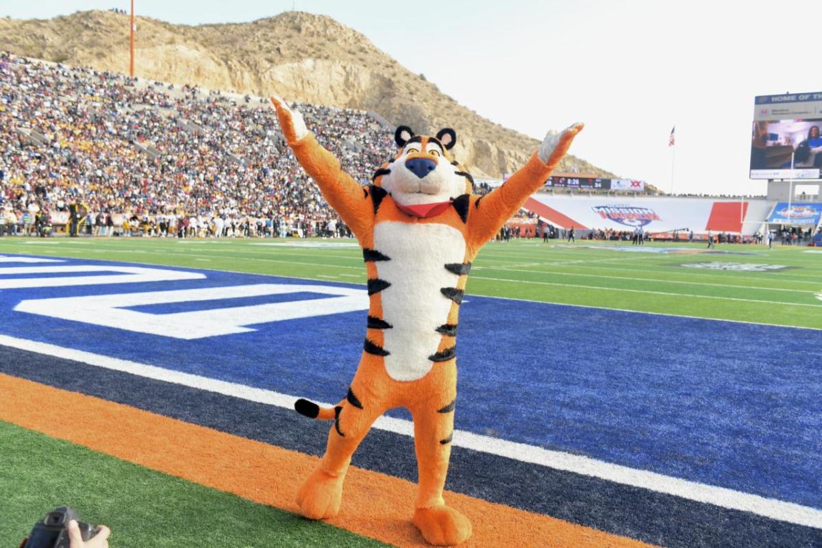 Tony the Tiger stands on football field 