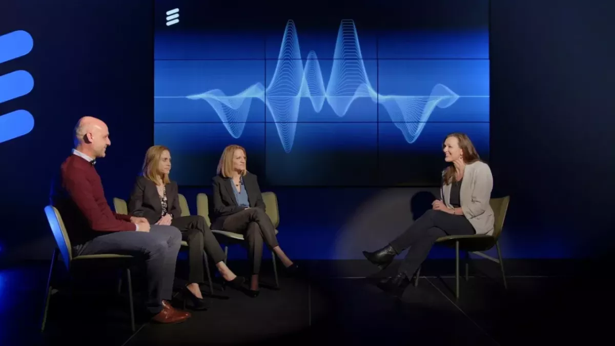 three people sat on chairs being interviewed by a person sat opposite 