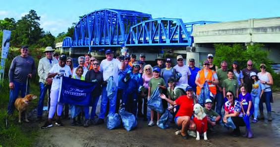 People standing together in front of a bridge