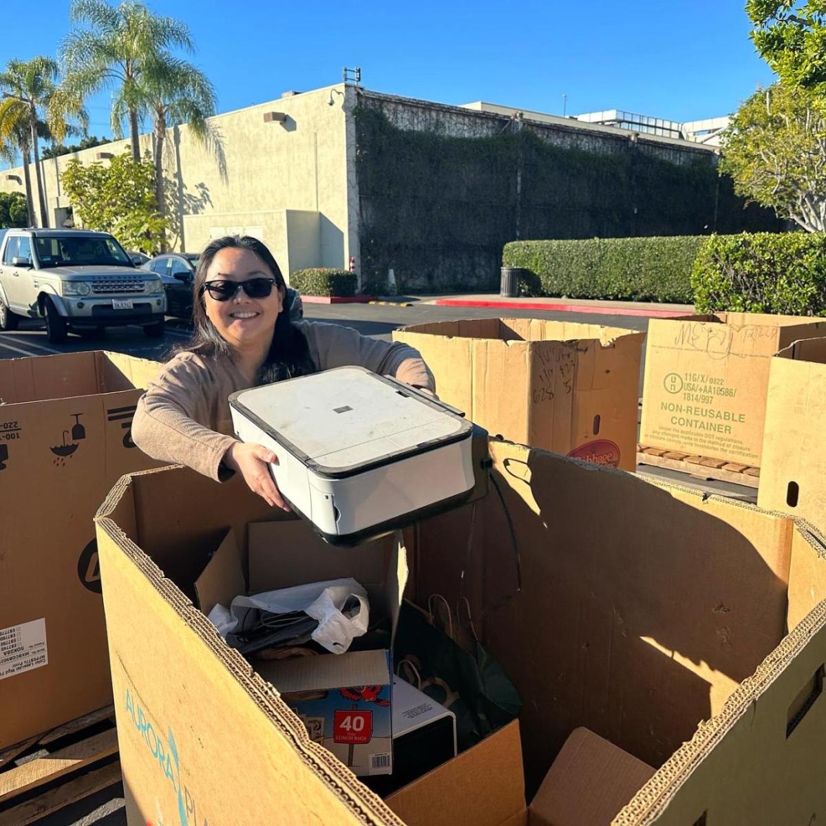 Woman placing computer in cardboard box
