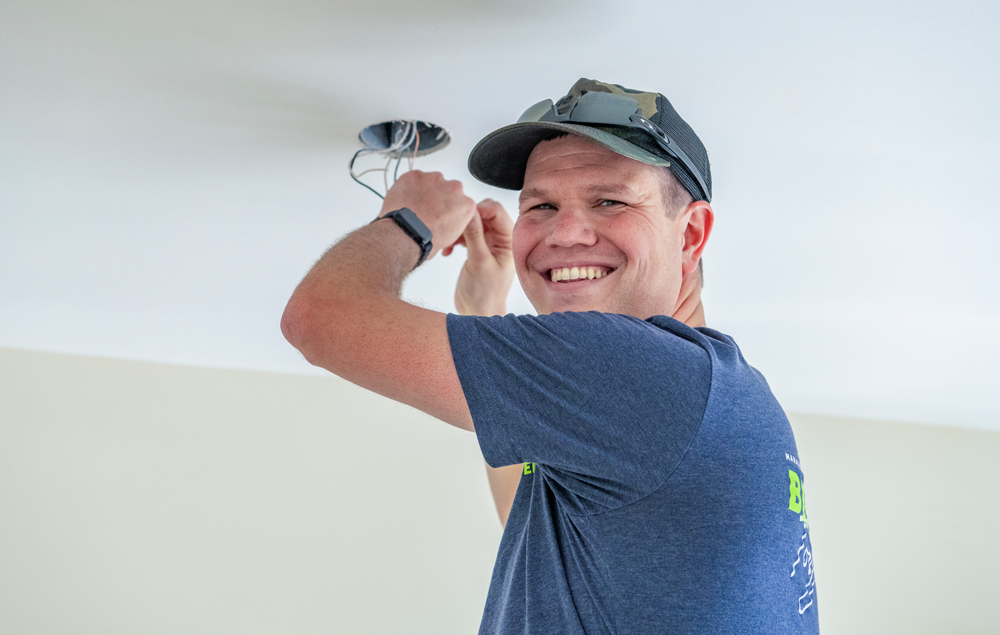 Person installing ceiling light