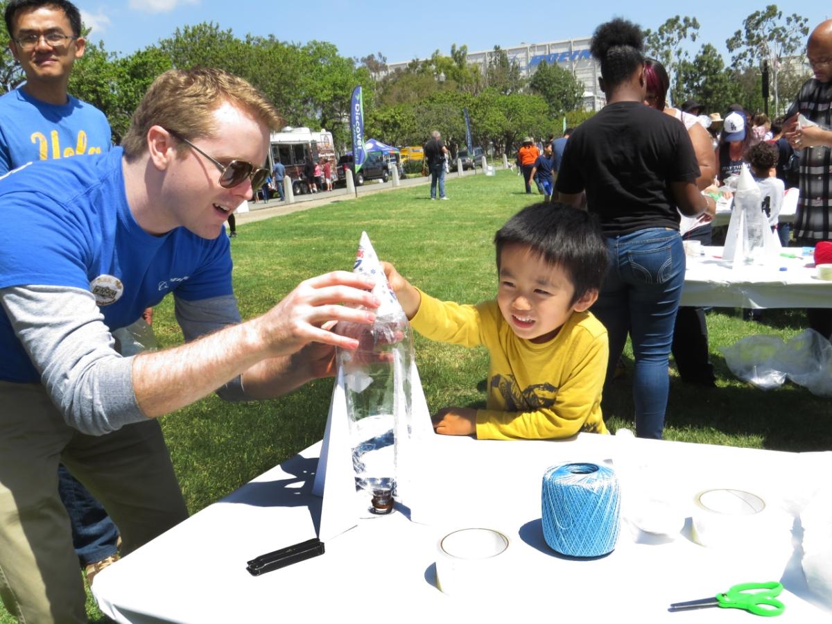 Boeing Engineer Kevin Rausch demonstrates the properties of rocket propulsion to a young innovator at Boeing's annual Southern California Rocket Launch event. Employee volunteerism plays an important role in inspiring change and making a positive, lasting impact in Boeing communities, worldwide.