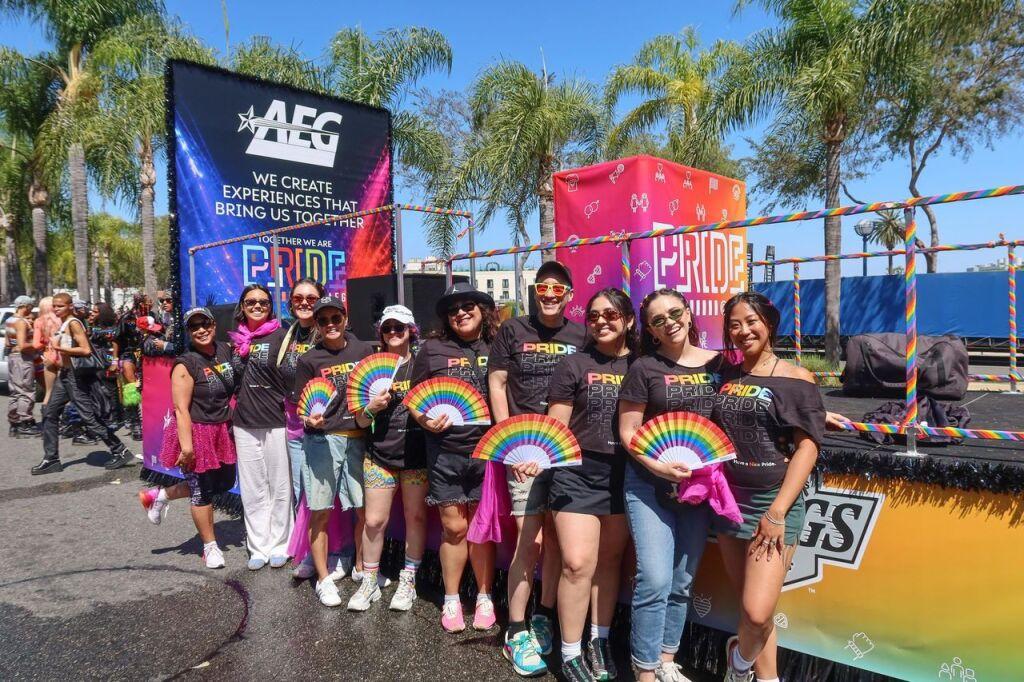 AEG Employees pose in front of Pride float