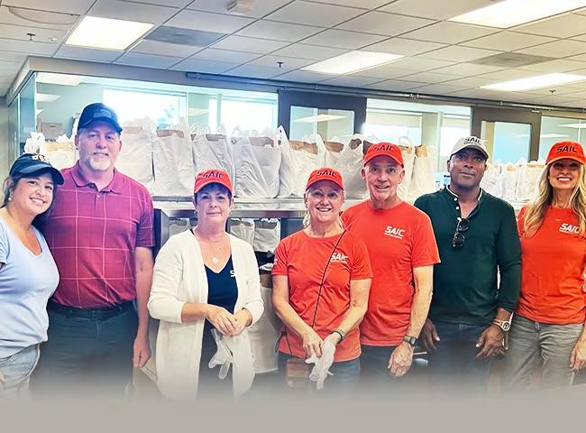 A group of SAIC employees volunteering at Mama's Kitchen 