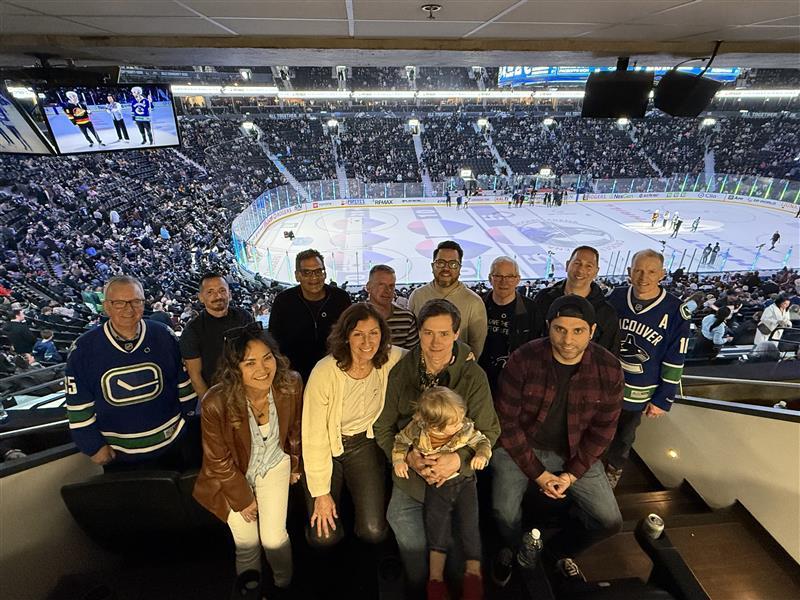 DP World employees and living donors group photo in DP World's suite at the Vancouver Canucks game