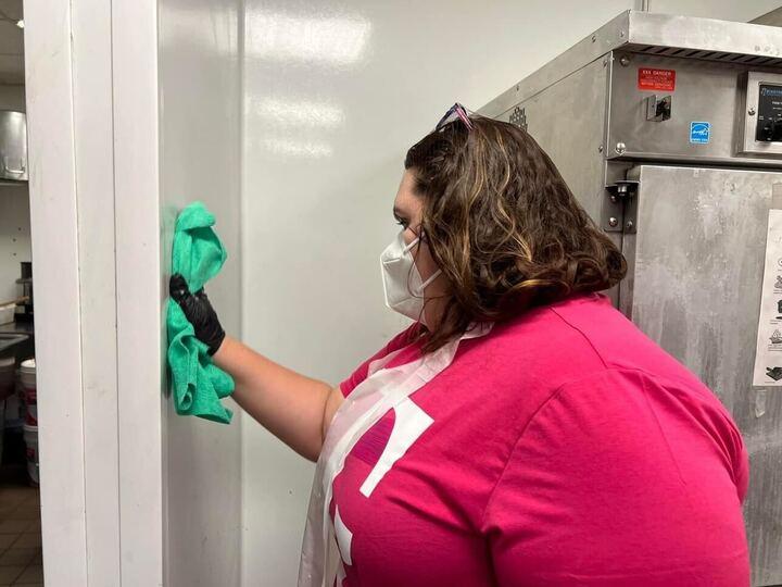 Person cleaning wall