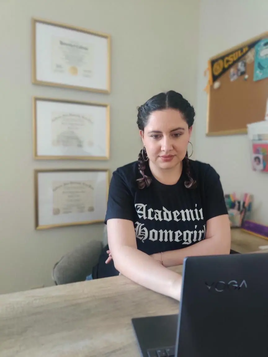 Dr. Maricela Becerra, using a laptop