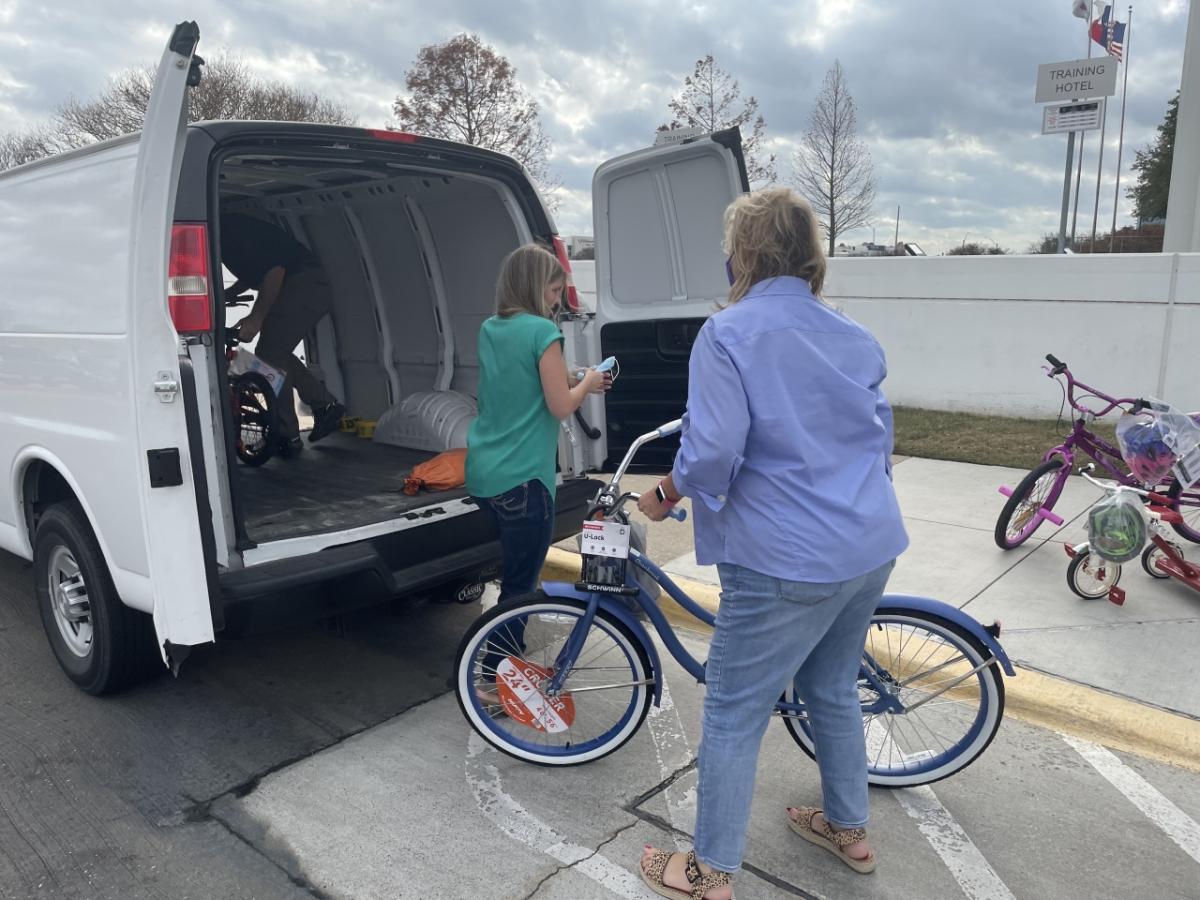 woman loading bike into van