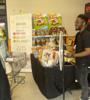 A person standing at a store with a booth