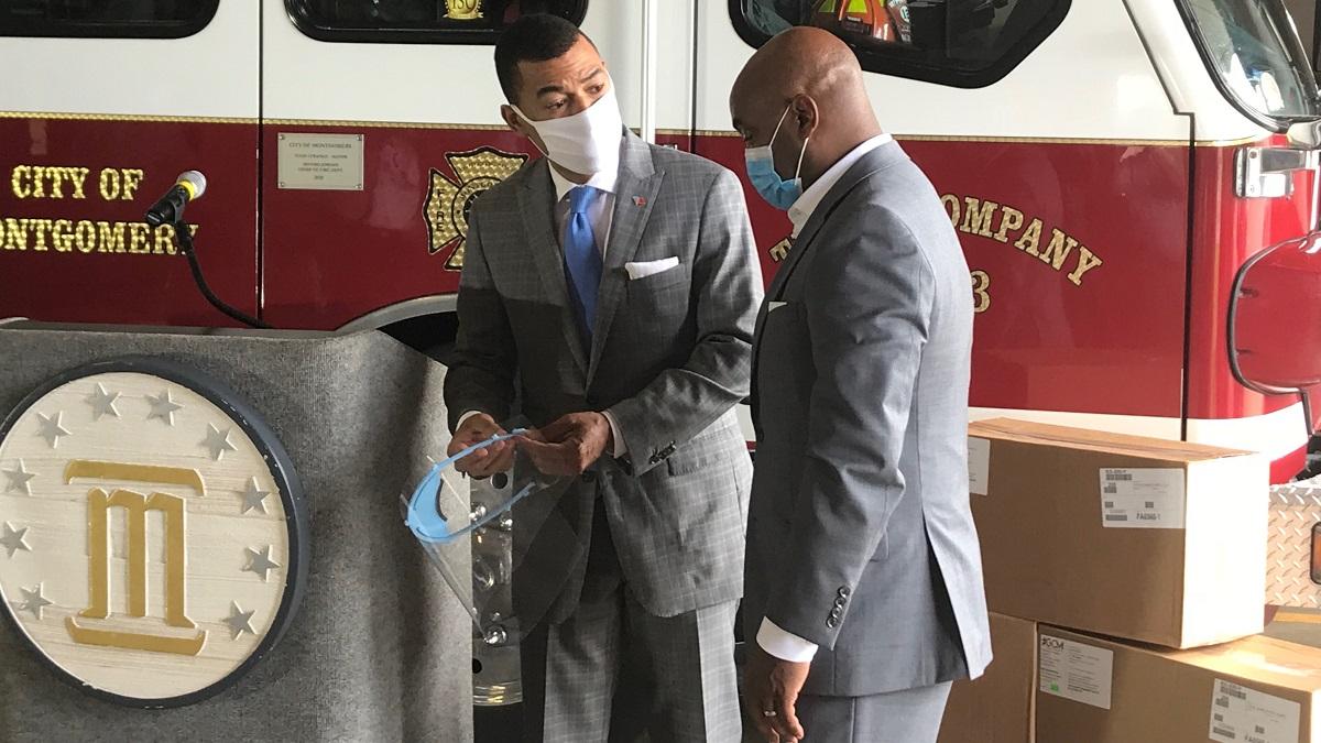 Montgomery Mayor Steven Reed, left, examines a face shield with retired Brig. Gen. Trent Edwards. It is one of 10,000 face shields AFLAC donated to the region. (Michael Jordan / Alabama NewsCenter)