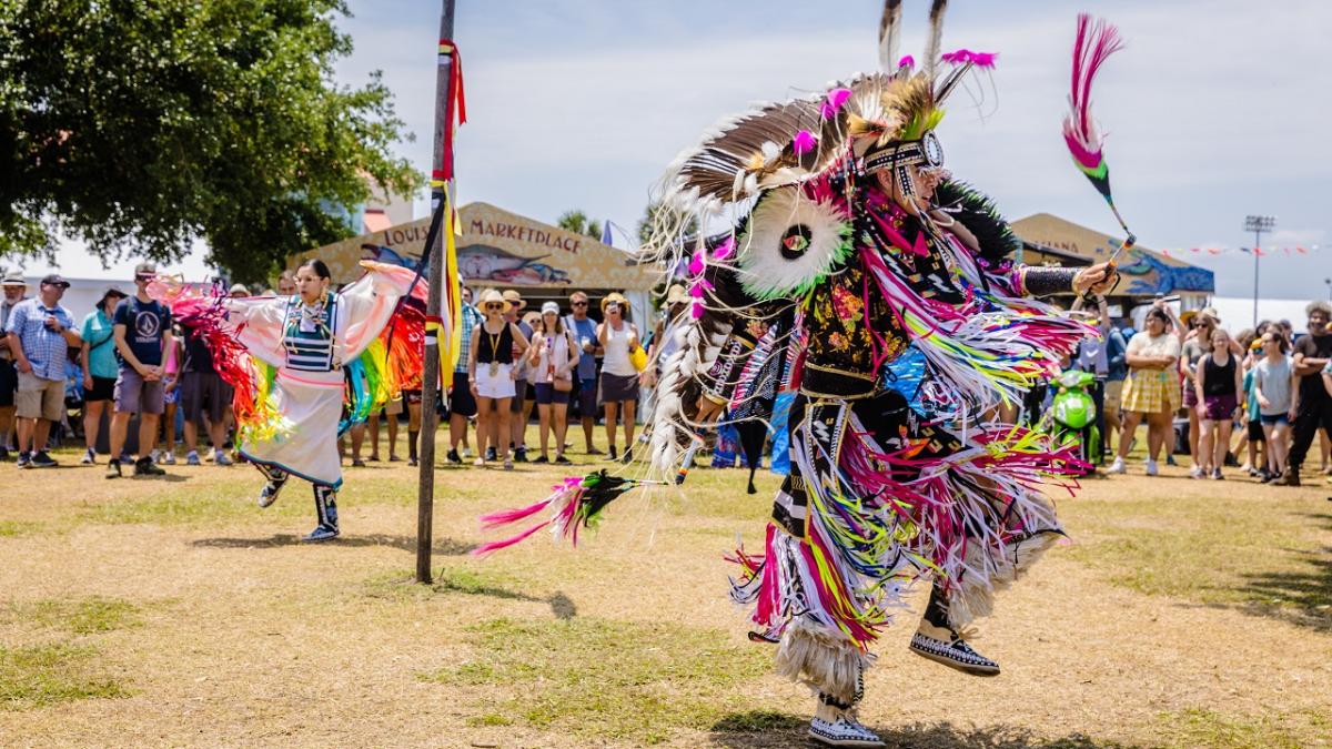 A person in traditional dress dancing.