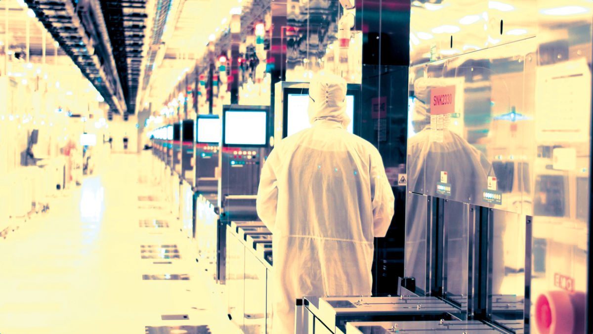 employee in clean suit in lab