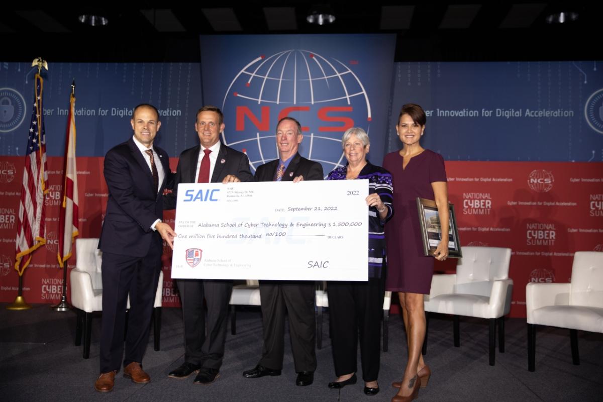 SAIC presents $1.5 Million check to the Alabama School for Cyber Technology and Engineering. Pictured from left are: SAIC Vice President of Operations, Greg Fortier; ASCTE School President, Matt Massey; ASCTE Foundation Board Vice President, Van Sullivan; ASCTE Board of Trustees retired Army Gen. Barbara Fast; ASCTE Board of Trustees and ASCTE Foundation Executive Director, PeggyLee Wright.