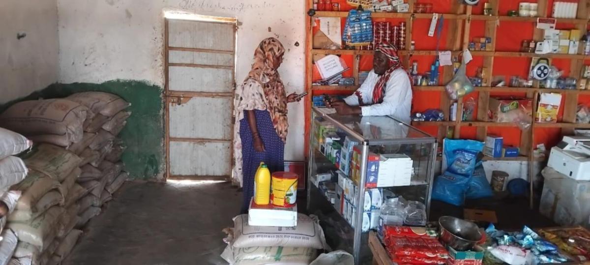 Abshiro purchases food with cash assistance support from Action Against Hunger, funded by EU Humanitarian Aid.