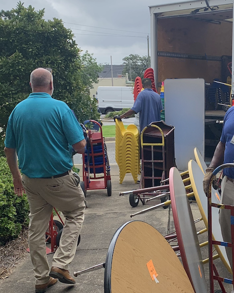 Donated furniture for the school system is being loaded into a truck.