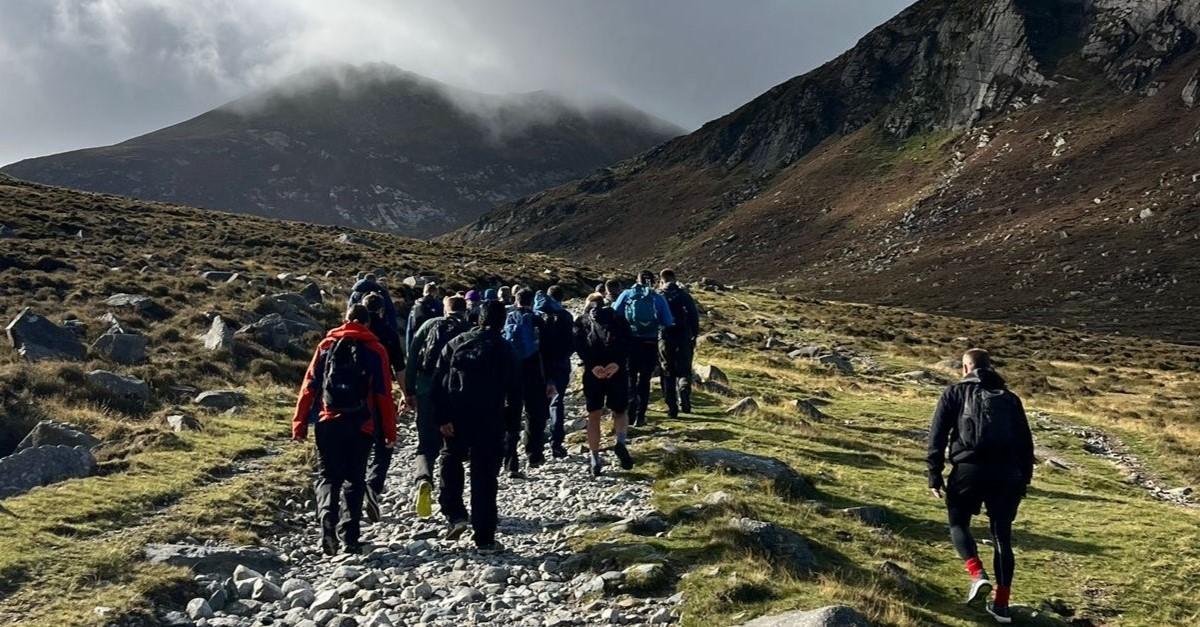 Aflac Northern Ireland volunteers on the Three Peaks Challenge, a trek to the Mournes that includes Slieve Binnian, Slieve Commedagh and, finally, an ascent to the top of Slieve Donard.