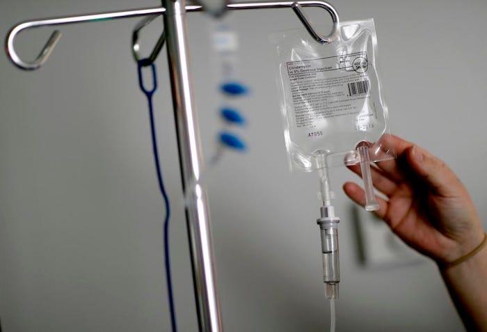 Many Americans face substantial medical dept. (AP Photo/David Goldman, File) ASSOCIATED PRESS Hanging medical bag with a hand touching the bag.